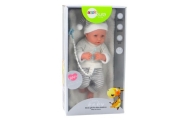 Baby doll in white and gray striped clothes, hat, pacifier, quilt