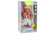 Baby doll in white and pink clothes, hat, pacifier, and blanket