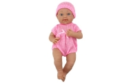 Baby doll in pink clothes, hat, pacifier, and blanket